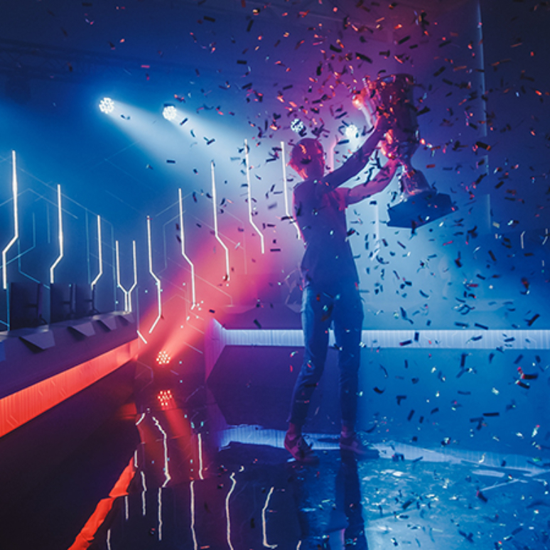 Esports,Winner,Trophy,Standing,On,A,Stage,In,The,Middle